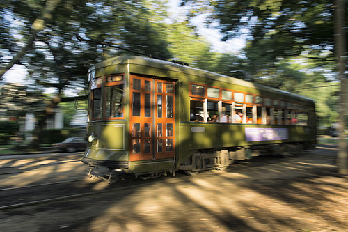 A traditional street car cruises through the Garden District