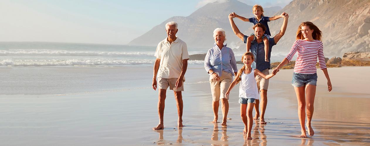 Family spanning three generations on a beach getaway