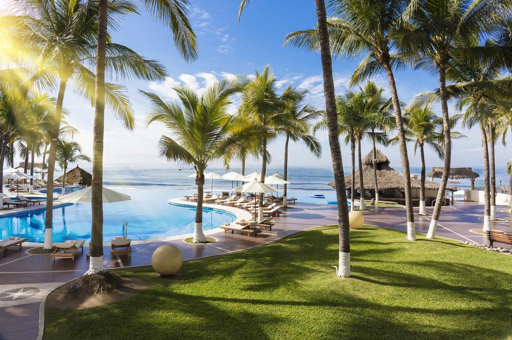 Sit by the pool and enjoy stunning views with Reflect Resorts & Spas