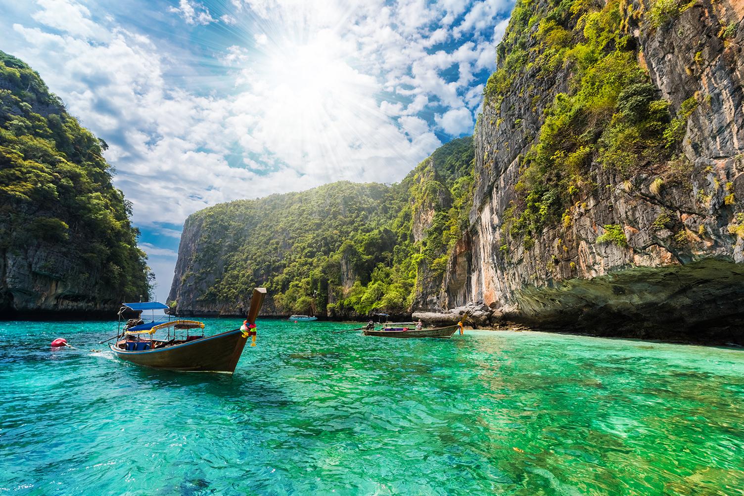 Experience boat tours through rocky inlets with Thailand vacation packages